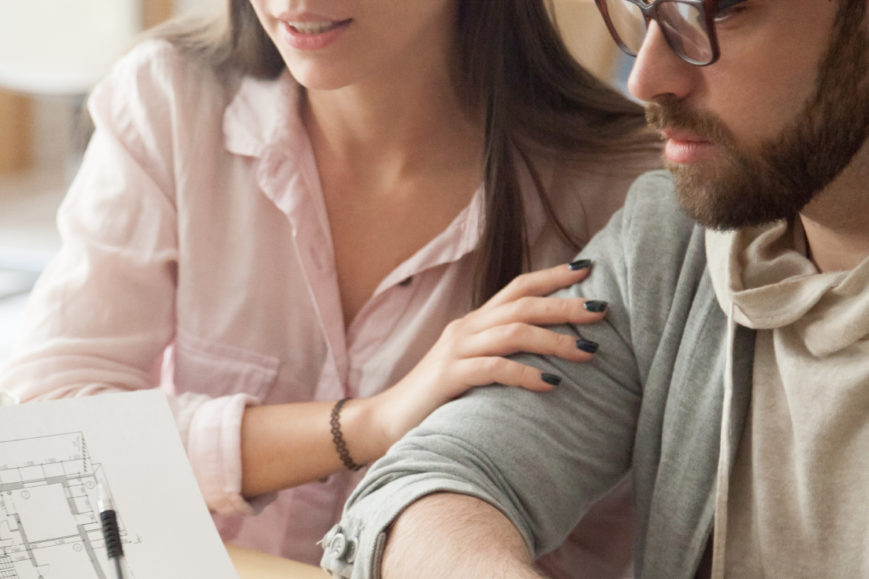 Millennial couple consulting about home design project in architect office