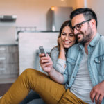 A couple watches Instant Experience ads on their phone.