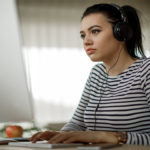 Young woman works at computer