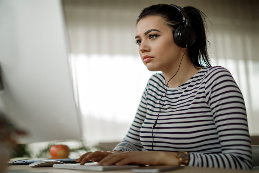 Young woman works at computer