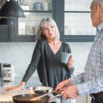 Adult couple cooks in their spacious kitchen.