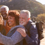 Group Of Senior Friends Posing For Selfie As They Hike Along Trail In Countryside Together.